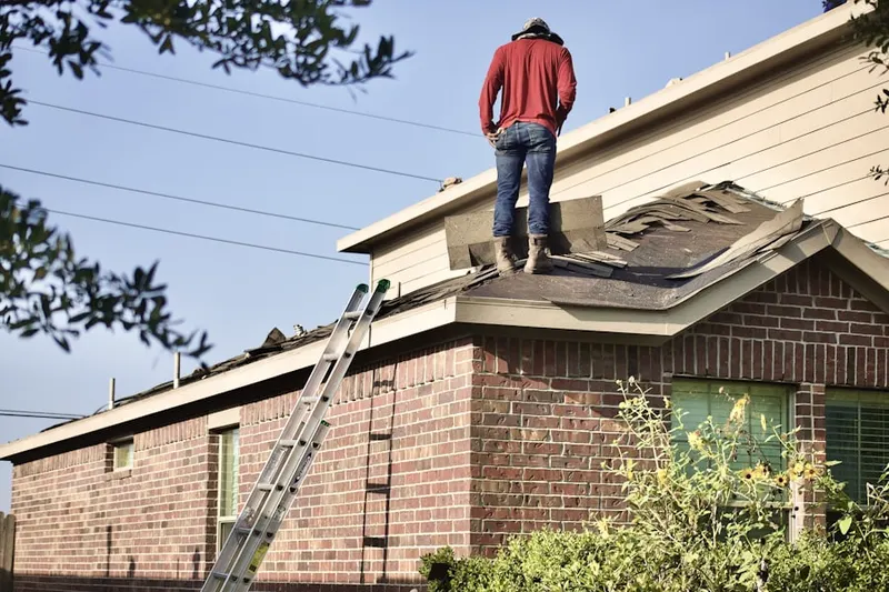 Professional roofer working on a residential roof in Portage Bay